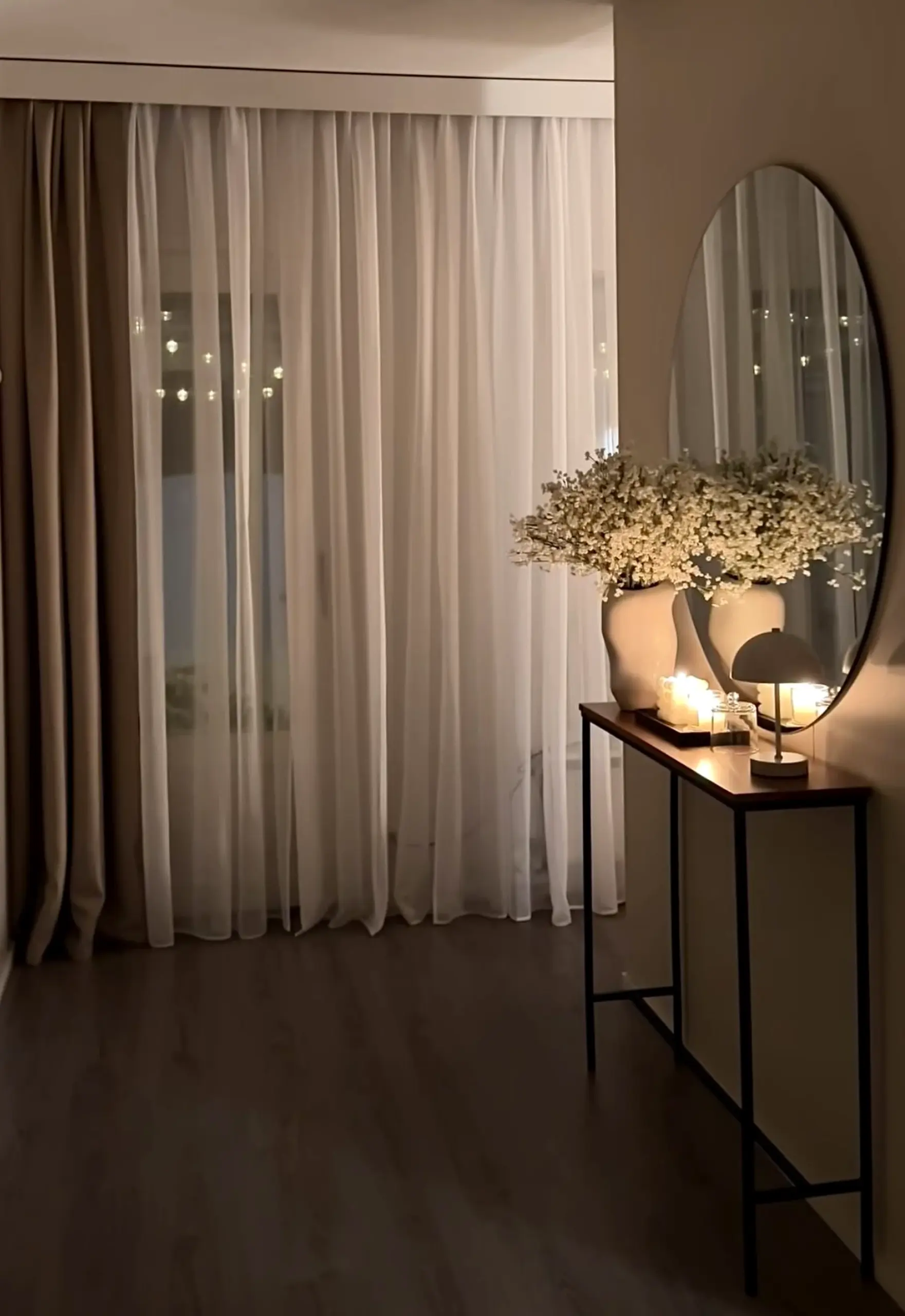 Polished vase display frames the room with depth, making the scene feel personal and relaxed.