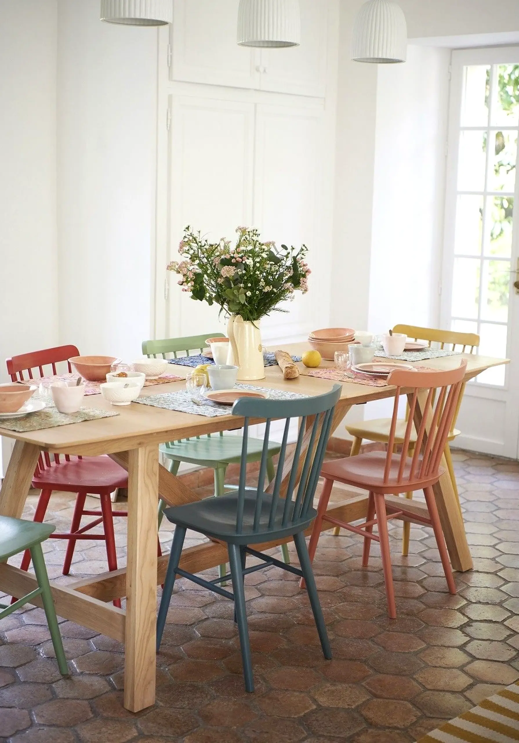 Colorful arched doorway anchors the garden edge with personality, giving the view a mood that feels fresh and intentional.
