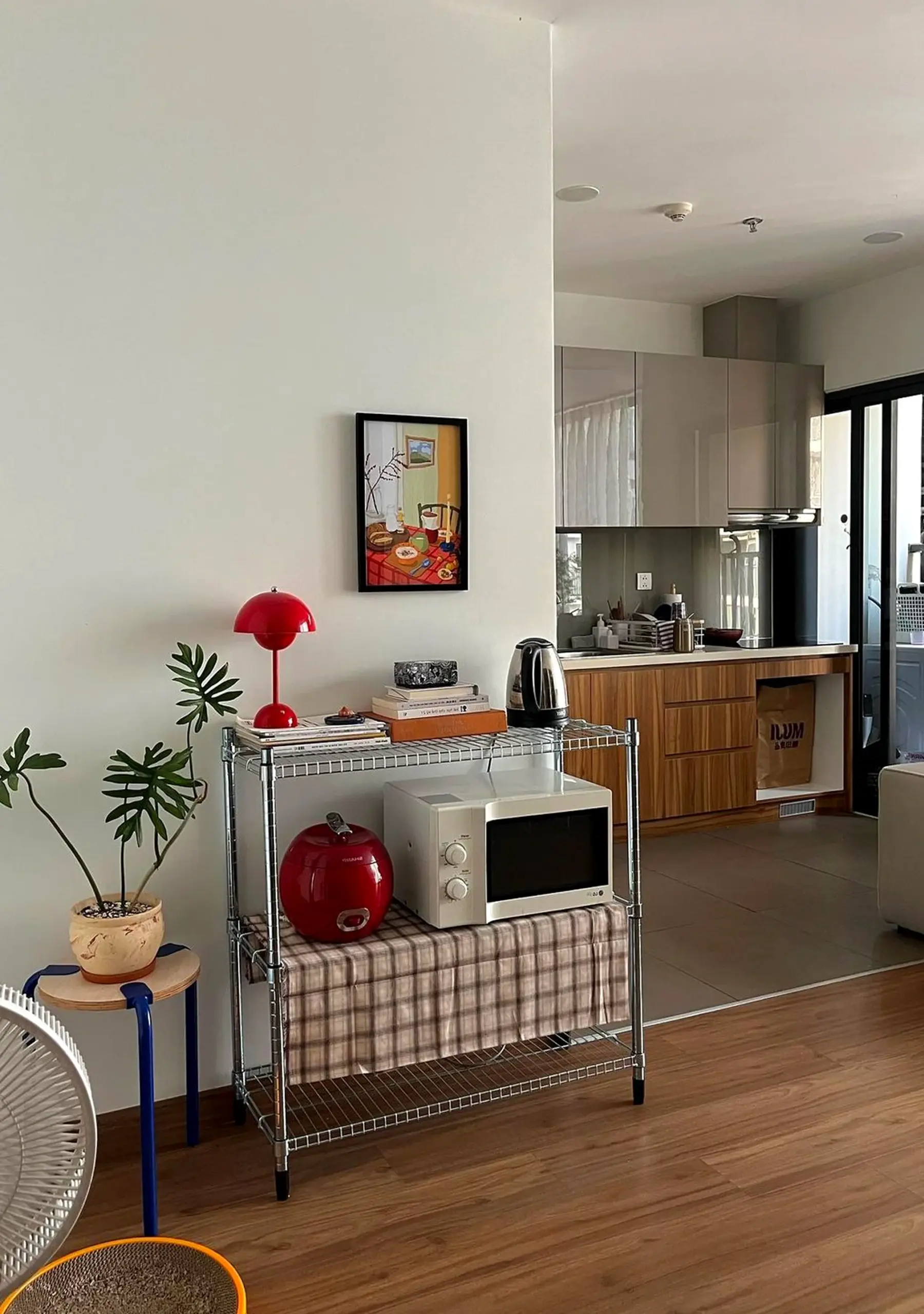 Warm greenhouse corner brings contrast to the room, creating a mood that feels visually grounded.